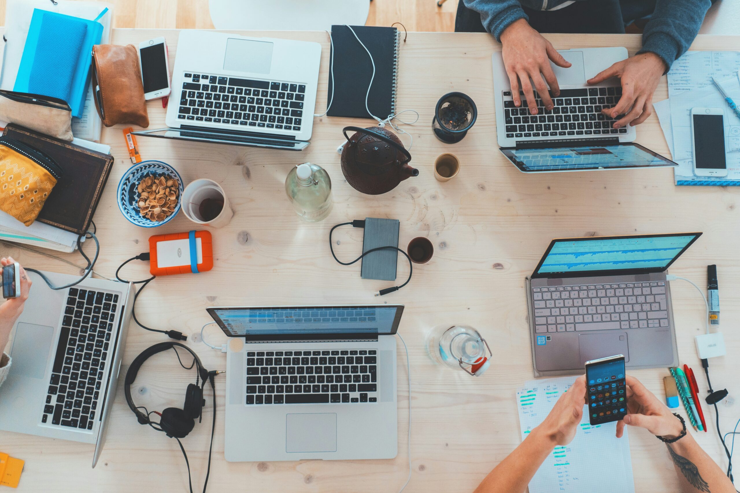 A collaborative workspace with connected laptops and business tools